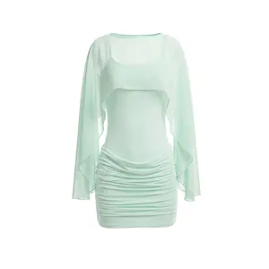 Detailed view of mint green mesh two-piece set with long-sleeved shawl and mini dress