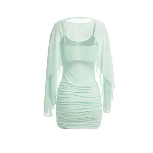 Detailed view showing the mint green mesh mini dress and matching sheer shawl cover-up.