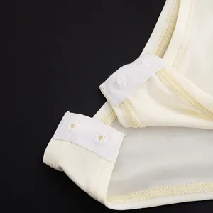 Detail of white mesh bodysuit showing high-quality snap button closure for easy wear.