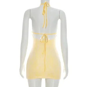 Detailed back view of a sexy yellow lace mini dress featuring a halter backless design.