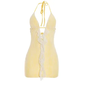 Detail showing the intricate white lace ruffle on a yellow halter backless mini dress.