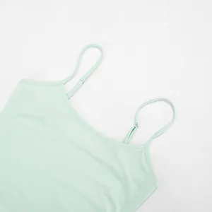 Detailed close-up view of a mint green camisole dress with adjustable spaghetti straps.