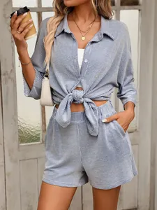 Stylish blue and white striped two-piece set featuring a tied shirt and shorts