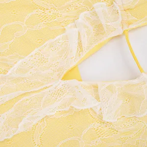 Detailed macro shot of yellow floral lace fabric and ruffled back cutout on mini dress