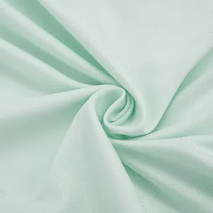 Macro detail of the breathable mint green ribbed fabric for a summer mini dress