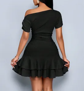 Detail view of black one-shoulder slim fit dress with ruffled hem and ribbed texture