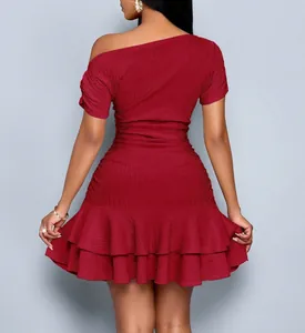 Detailed back view of a textured wine red one-shoulder dress featuring ruffled hem