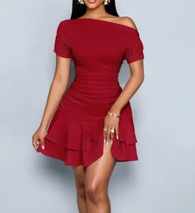 Detail view of a burgundy off-shoulder mini dress with ruffled hem and textured fabric