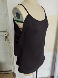 Detail view of black cold-shoulder T-shirt with strappy sleeve design on mannequin.