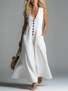 Detalle de vestido blanco sin mangas con cuello en V profundo, botones y bolsillos