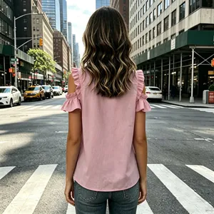 Back view of a pink ruffled off-the-shoulder chiffon blouse in city street