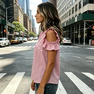 Detailed side view of a stylish pink cold-shoulder top featuring ruffles and button accents
