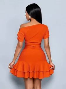 Back view of an elegant orange one-shoulder ruffle hem mini dress with textured fabric