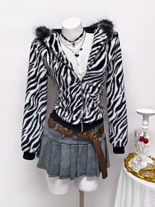 Macro view of plush texture on women's zebra print faux fur hooded zip-up jacket