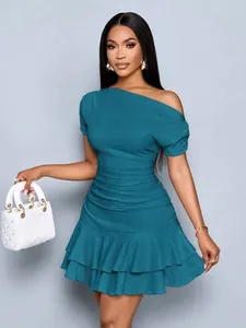 Elegant teal off-shoulder mini dress featuring textured pleated fabric and tiered ruffles.