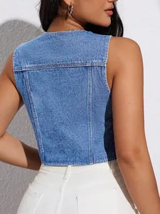 Close-up back view of a cropped blue denim vest on a model