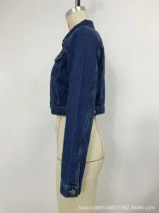 Side view detail of a stylish cropped blue denim jacket featuring classic button cuffs