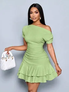 Elegant light green one-shoulder ruched mini dress with ruffle hem detail.
