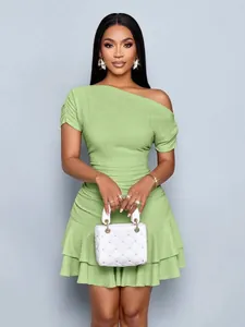 Elegant green one-shoulder mini dress with tiered ruffled hem and textured fabric