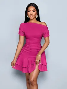 Detailed view of hot pink one-shoulder ruffle dress with textured fabric finish