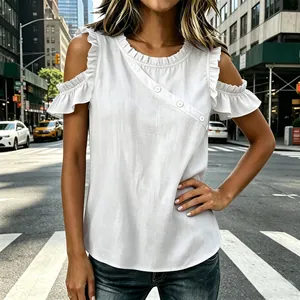 Close-up of white cold shoulder blouse with ruffled sleeves and decorative buttons.