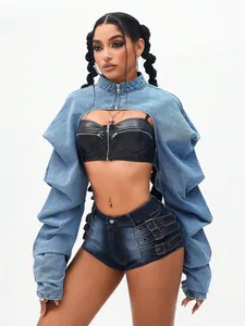 Women's trendy ultra-cropped blue denim shrug jacket styled over black leather corset top.