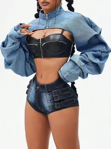 Detail view of a trendy denim shrug jacket with streetwear leather bustier and buckled shorts