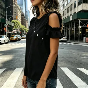 Detail view of a stylish black cold shoulder blouse with ruffles and button accents