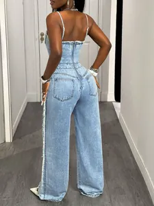 Detailed back view of sexy light blue denim jumpsuit with zipper and frayed edges