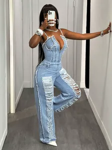 Detailed view of a sexy light blue denim jumpsuit with heavy distressed ripped legs.