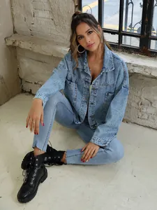 Detailed view of women's retro loose denim jacket with large pockets and button closure
