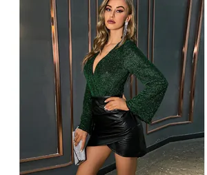 Detailed view of women's black PU leather mini skirt with irregular wrap waist design