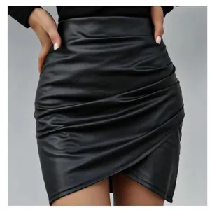 Black high-waisted PU leather mini skirt with ruched details and asymmetrical hem