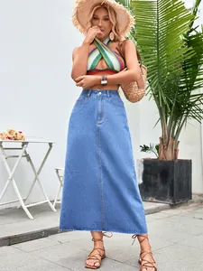Fashionable high-waist A-line denim maxi skirt with a raw hem and medium blue wash.