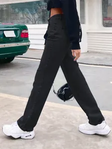 Street style view of high-waisted black straight-leg denim pants for women's fashion