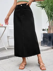 Detailed shot of a black high-waisted denim A-line midi skirt with a raw hem edge