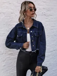 Close-up detail of dark blue cropped denim jacket with raw fringe hem and metal buttons