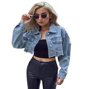 Trendy women's cropped light blue denim jacket with distressed details and frayed hem
