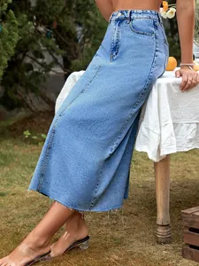 Detailed macro shot of a light blue high-waisted A-line denim skirt with raw hem edge