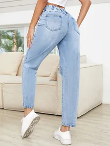 Back view detail of women's light wash ripped straight-leg jeans with high paperbag waist