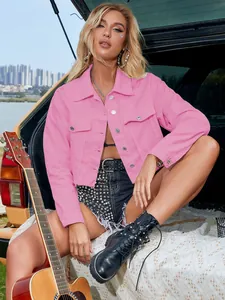 Stylish pink cropped denim jacket featured in an outdoor lifestyle setting on a fashion model