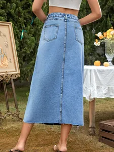 Detailed back view of a high-waisted light blue denim A-line skirt with a raw hem.