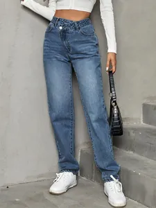 Detail view of high waisted loose denim jeans with unique asymmetric button closure