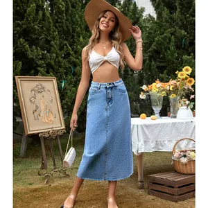 Outdoor lifestyle shot of a stylish high-waist denim A-line midi skirt with raw hem details