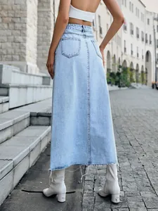 Rear view of a light blue denim A-line maxi skirt with raw hem and high waist design