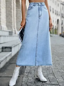 Stylish high-waisted A-line light blue denim maxi skirt featuring a trendy raw hem and center seam