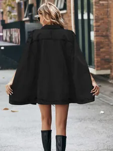 Back view of a trendy black oversized denim cape jacket featuring a stylish irregular hemline