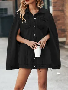 Stylish black denim cape jacket with irregular hem worn by model in urban setting