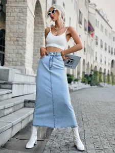 Chic light blue high-waisted denim maxi skirt featuring a trendy raw hem finish