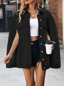 Stylish oversized black denim cape jacket with unique split sleeves shown on model outdoors